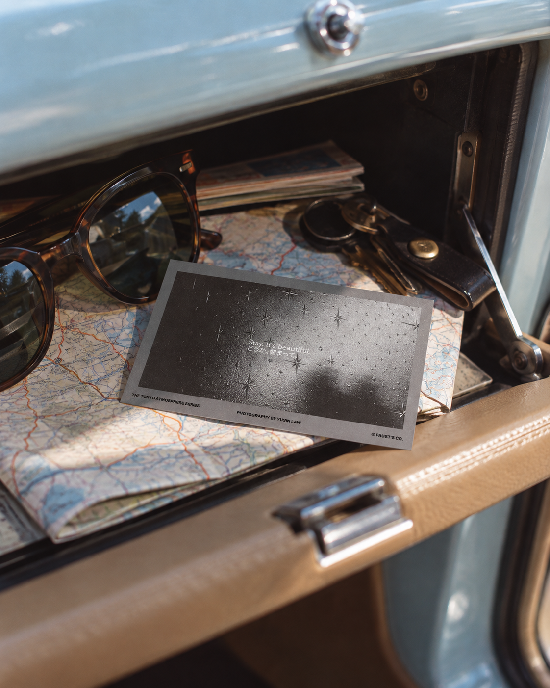 The Tokyo Atmosphere · Blur, a small fragrance card resting on a folded map beside sunglasses in a parked car.